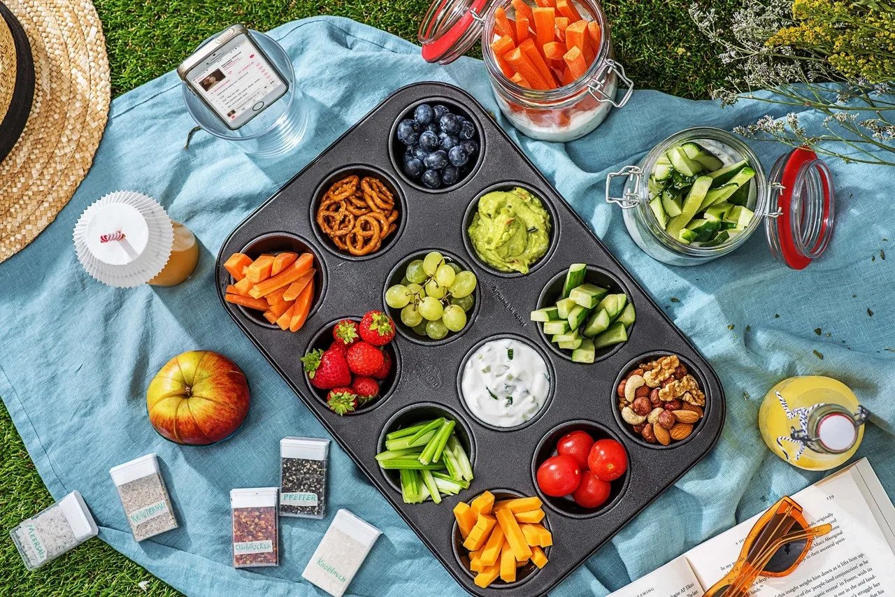 a picnic blanket on grass with picnic food. This is a pest-free picnic.