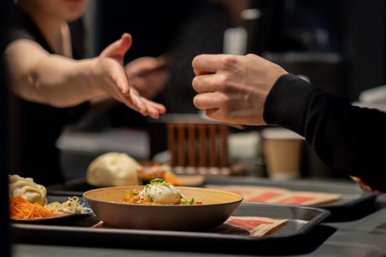 A waitress going to shake the hand of her customer. Local restaurants