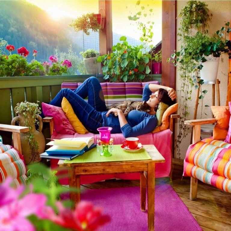 a lady lying on a sofa on a balcony with peace of mind