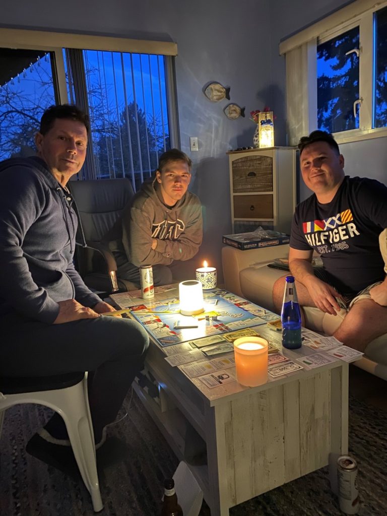 Stephen, Tayler and Cruz Scott playing monopoly by candlelight. It's a family business.